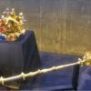 The use of a golden scepter in giving a large blessing to the people. 